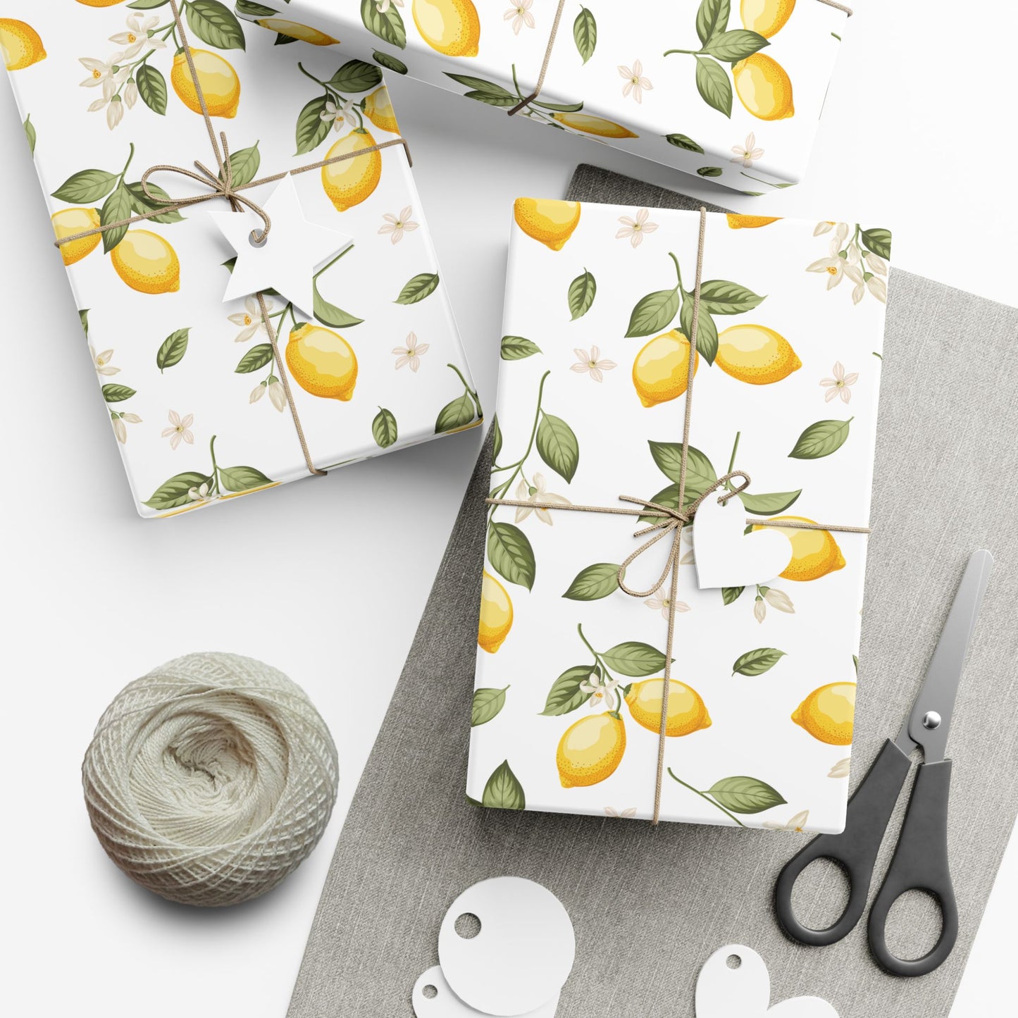 Gifts wrapped in lemon blossom paper with scissors and twine