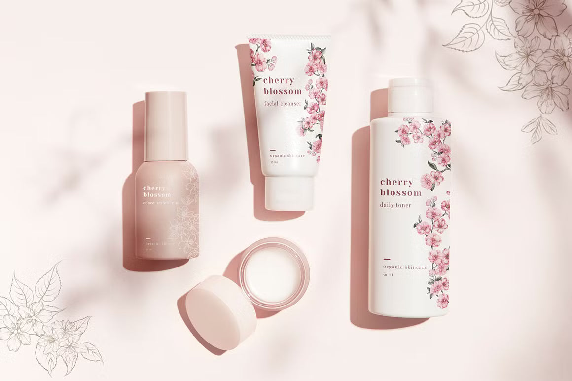 Skincare bottles and tube with pink floral Blooming Paris packaging