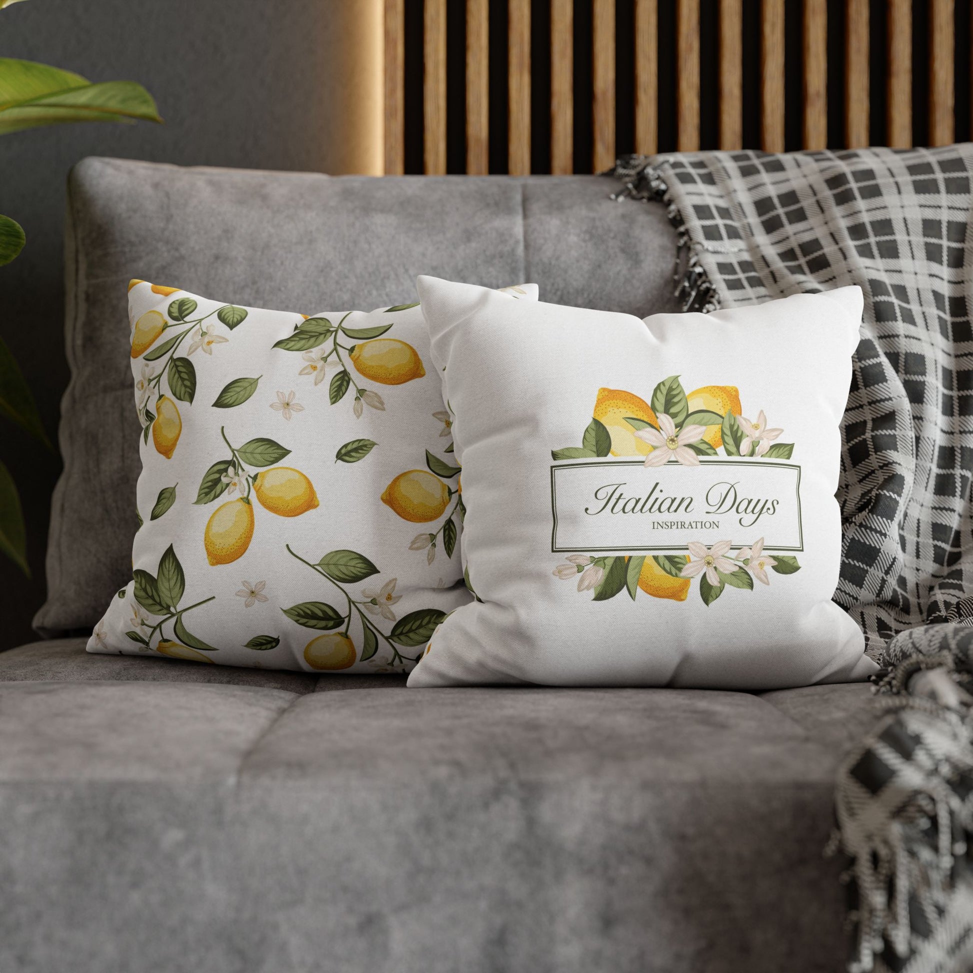 Italian Days label and lemon pattern pillow covers styled together on a gray sofa
