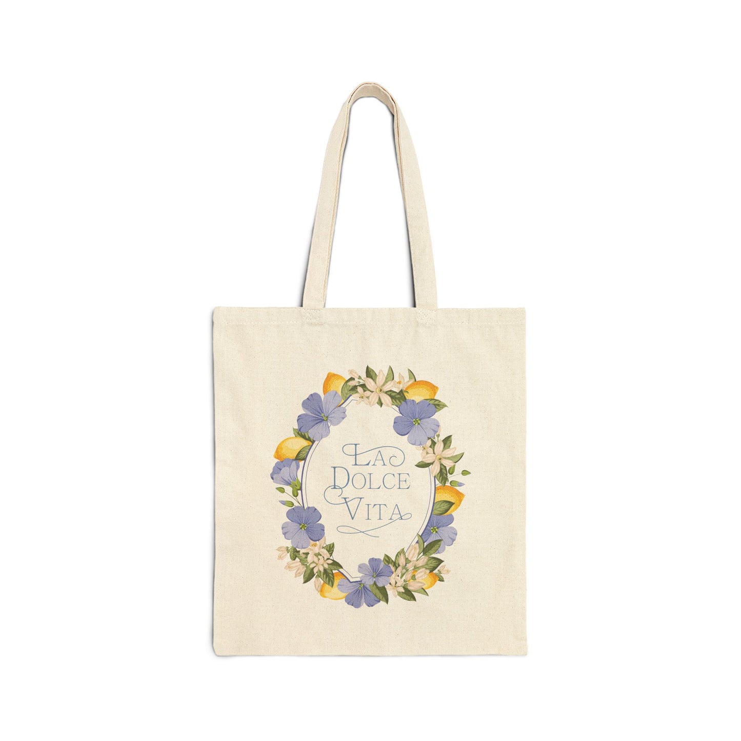 Flat front view of the natural canvas tote bag printed with a lemon and violet floral wreath framing the words La Dolce Vita