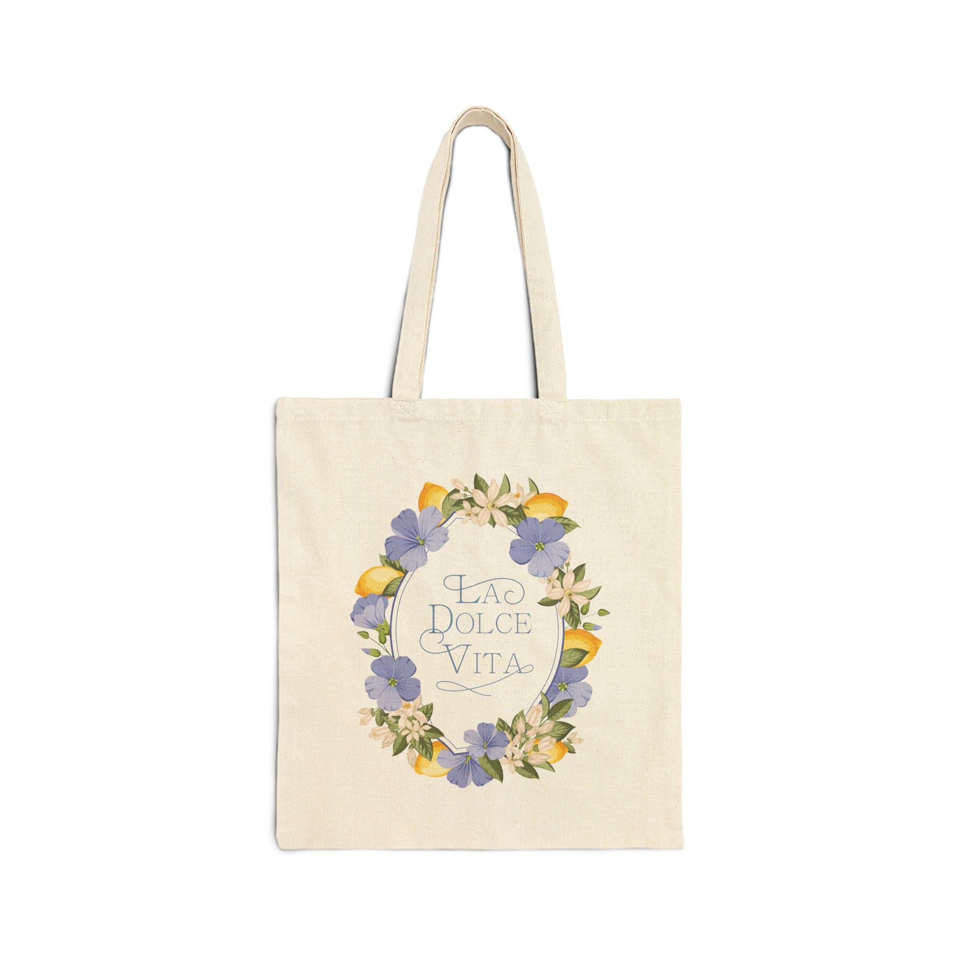 Flat front view of the natural canvas tote bag printed with a lemon and violet floral wreath framing the words La Dolce Vita