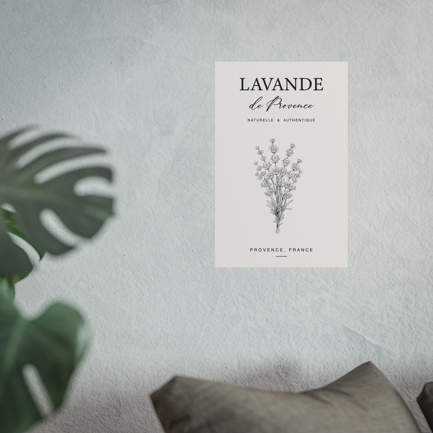 Lavande de Provence botanical print on a light grey wall beside a monstera plant in a minimal interior