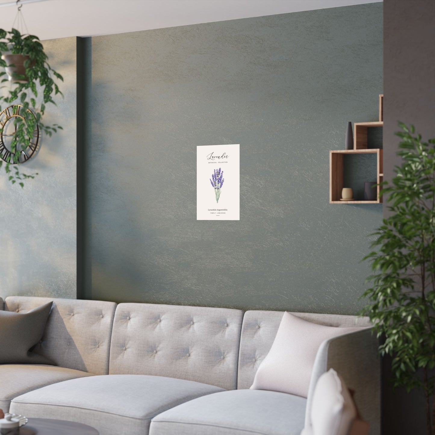 Lavender botanical poster hung on a sage green wall above a curved cream sofa in a modern living room with plants and wooden shelving