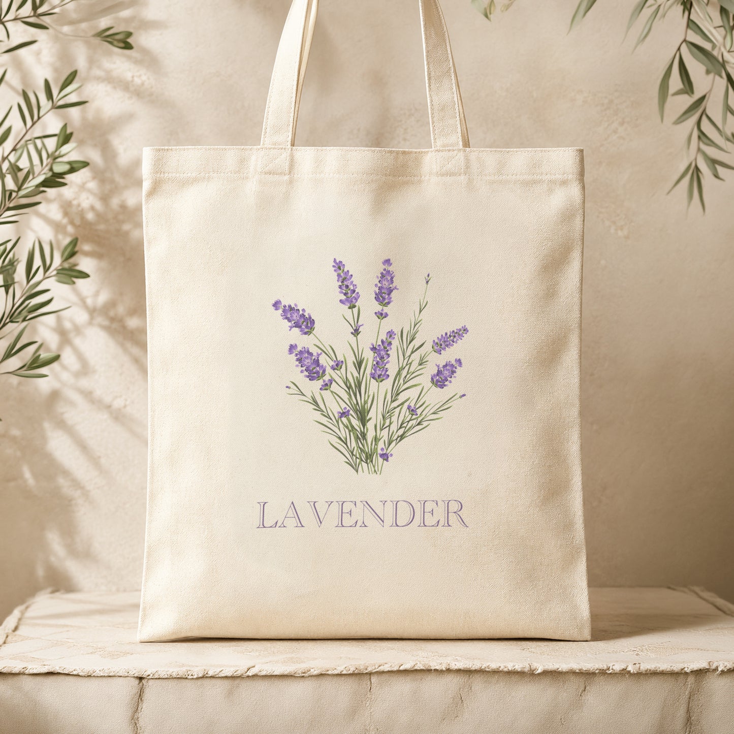 Back view of the natural canvas tote bag displayed on a cream textured surface with lavender botanical sprig illustration visible