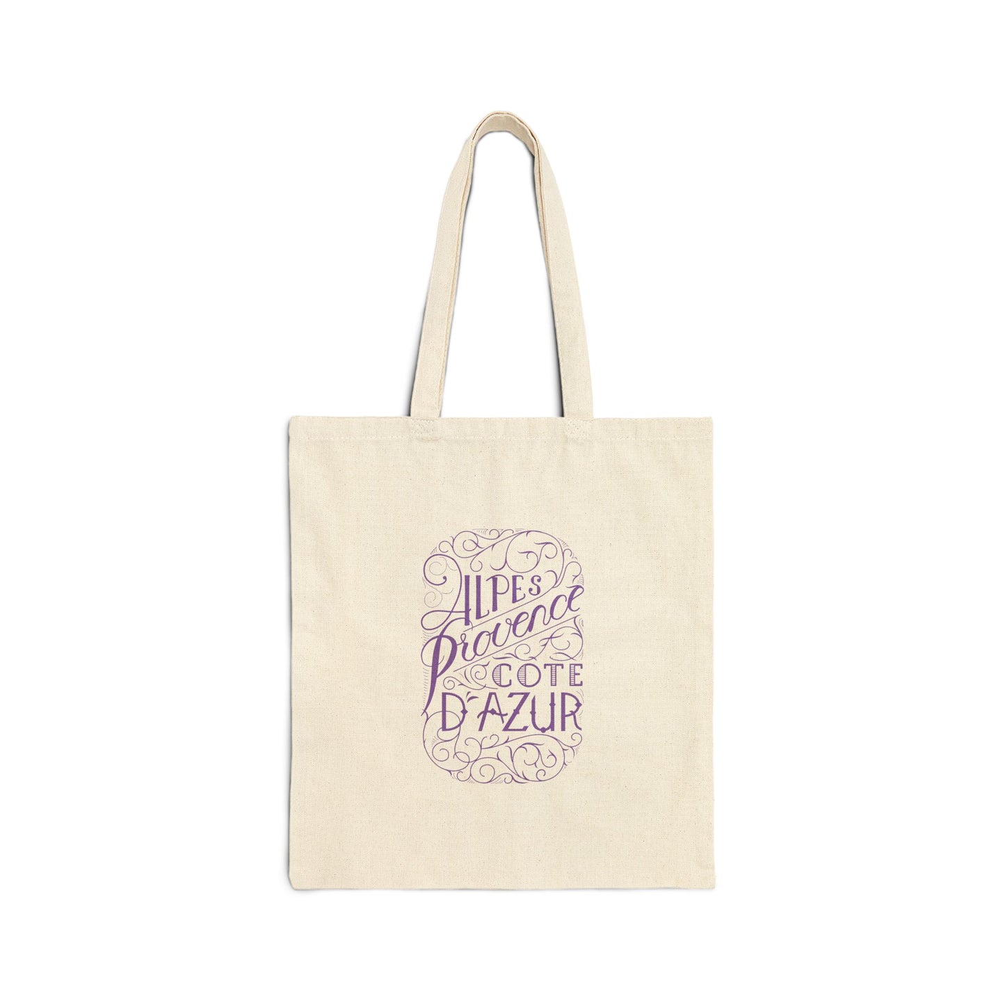 Flat front view of the natural canvas tote bag printed with ornate purple text reading Alpes Provence Cote d'Azur