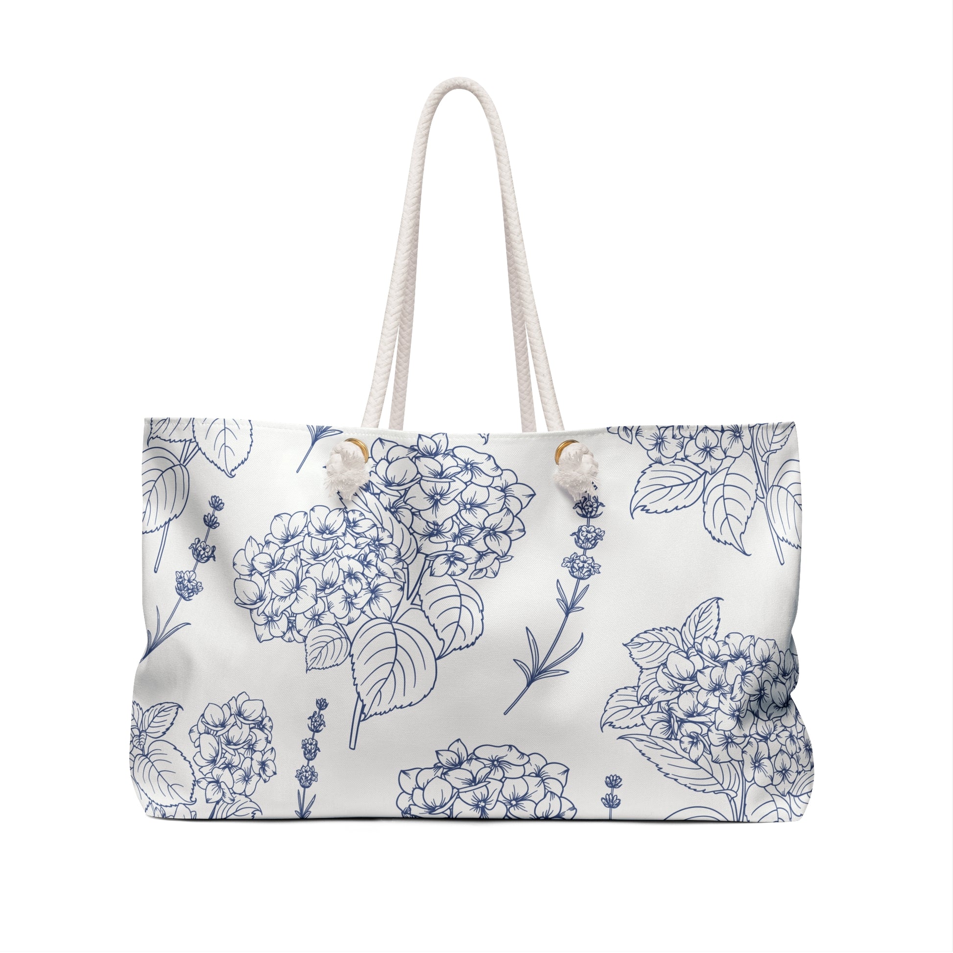 Close-up of the weekender bag front showing detailed lavender and hydrangea botanical pattern in indigo ink on a cream background