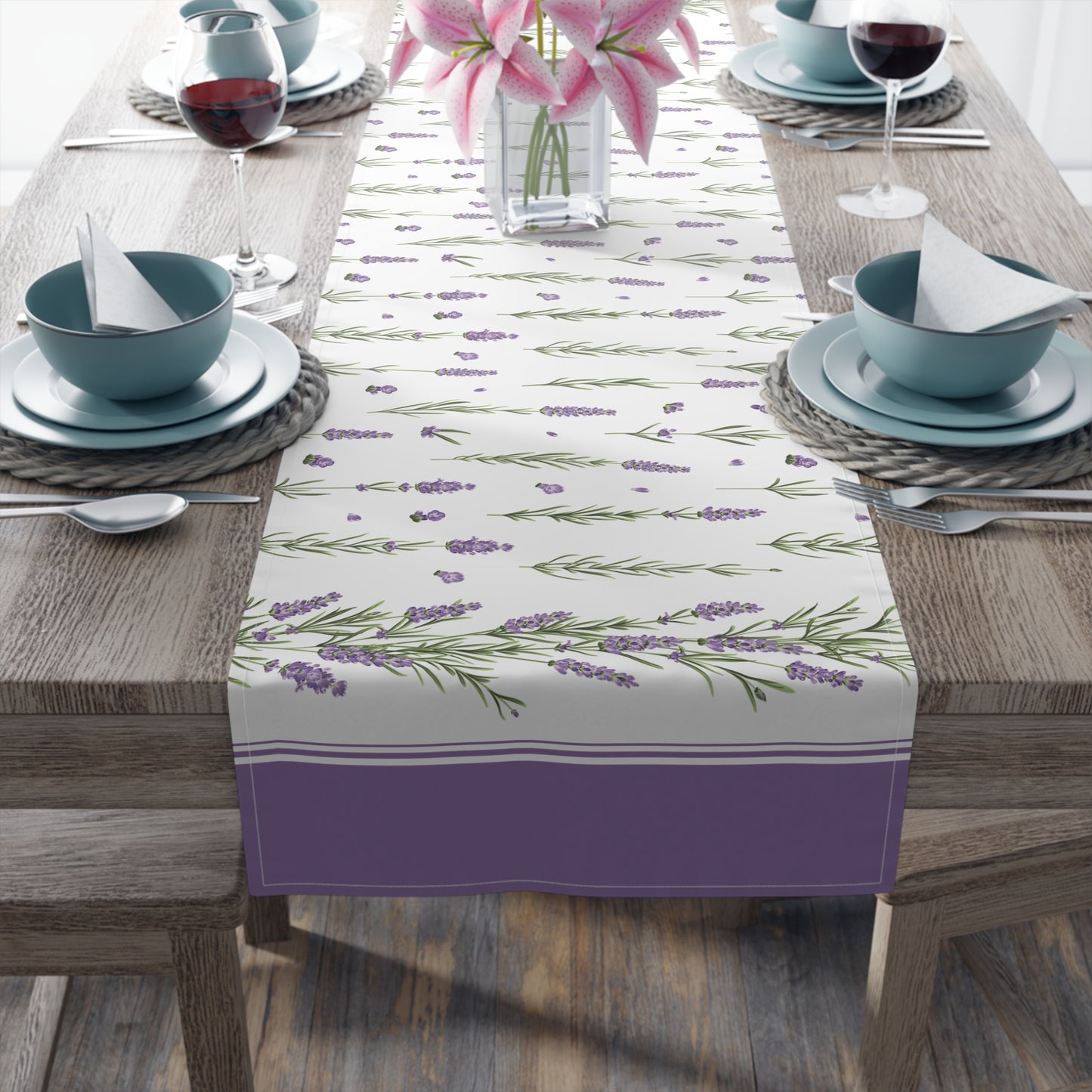 Lavender sprig table runner styled on a dining table with wine glasses and pink lilies