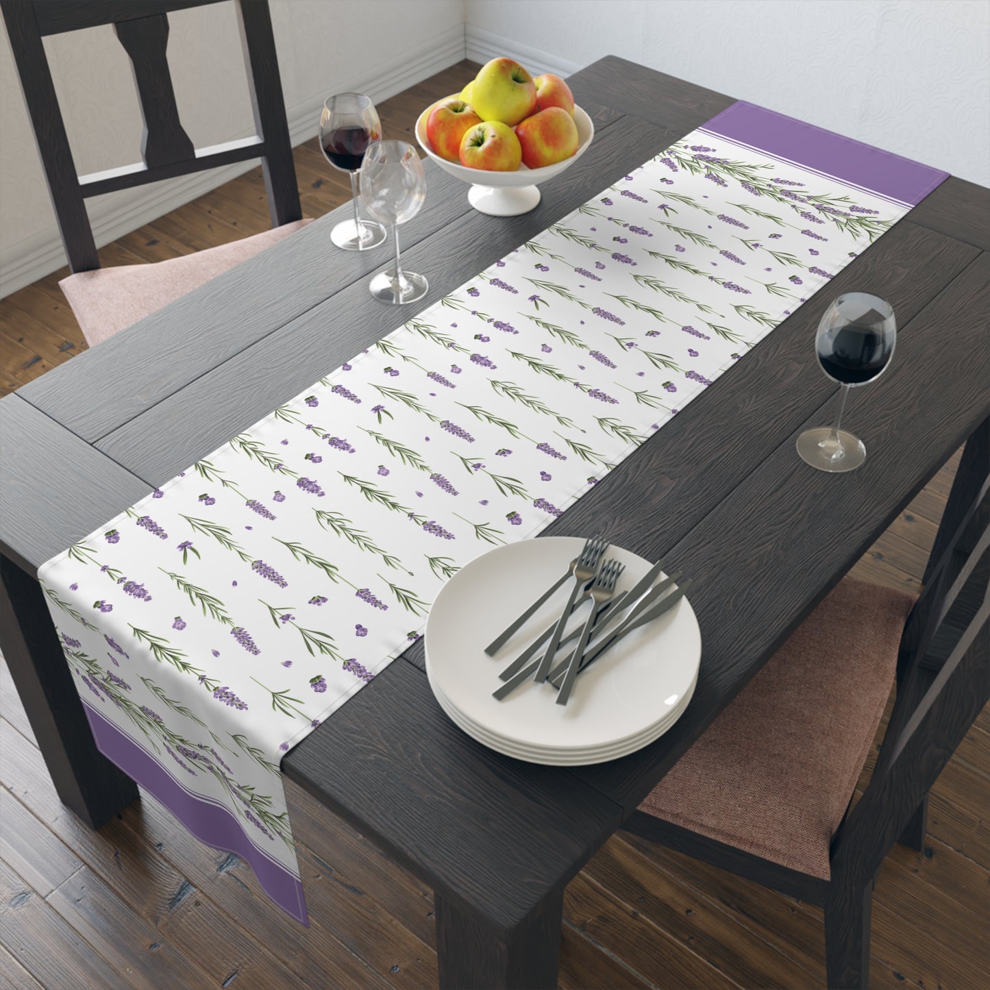 Lavender sprig table runner styled on a dark wood table with a fruit bowl and wine glass