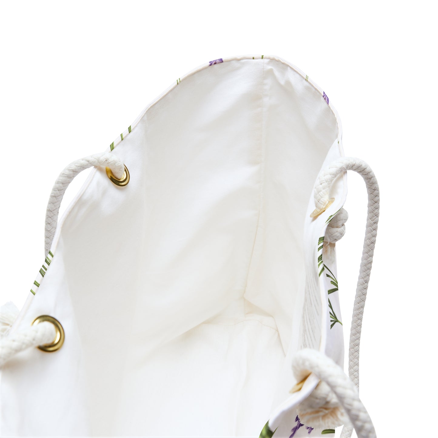 Close-up of the weekender bag's cream interior lining and rope handle grommets