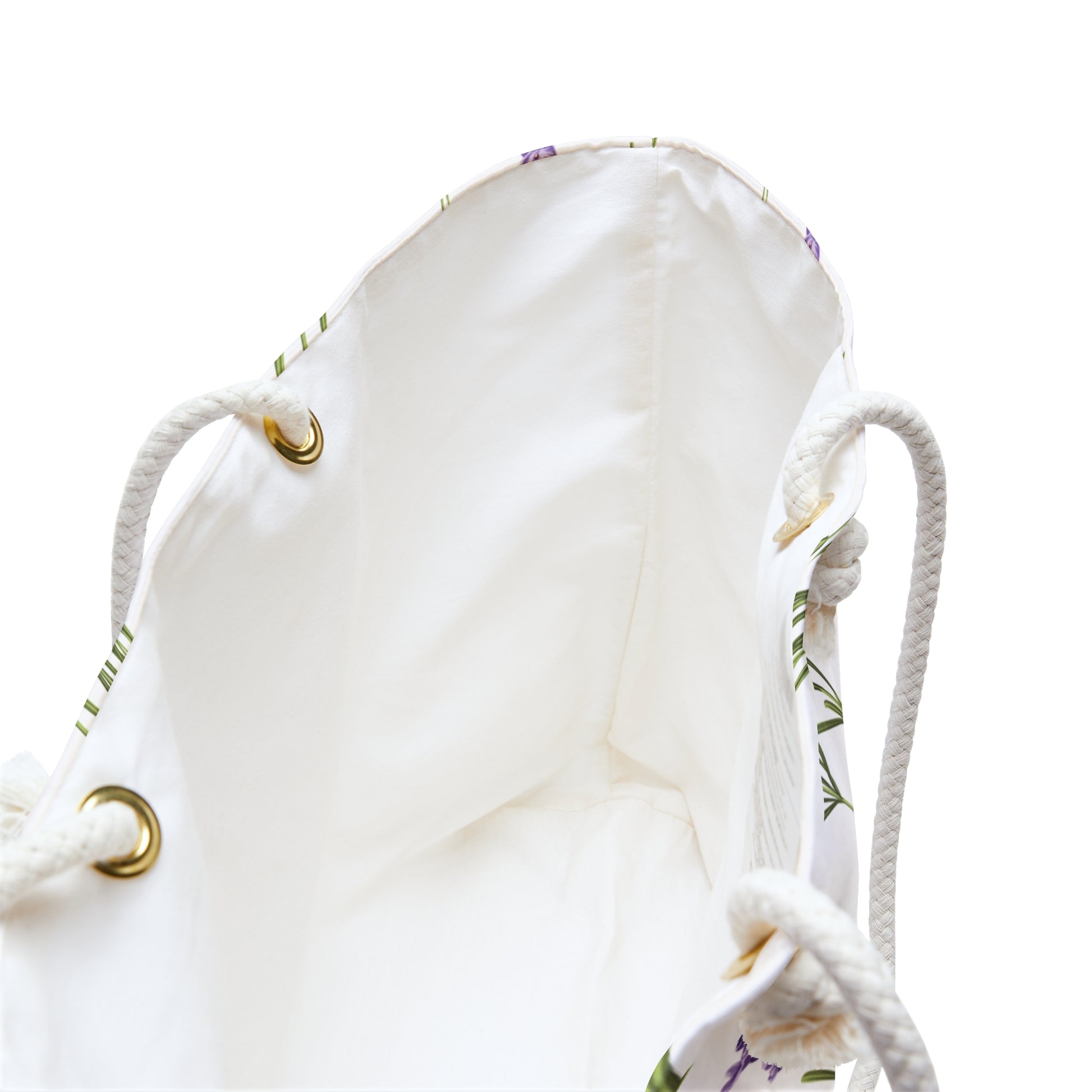 Close-up of the weekender bag's cream interior lining and rope handle grommets