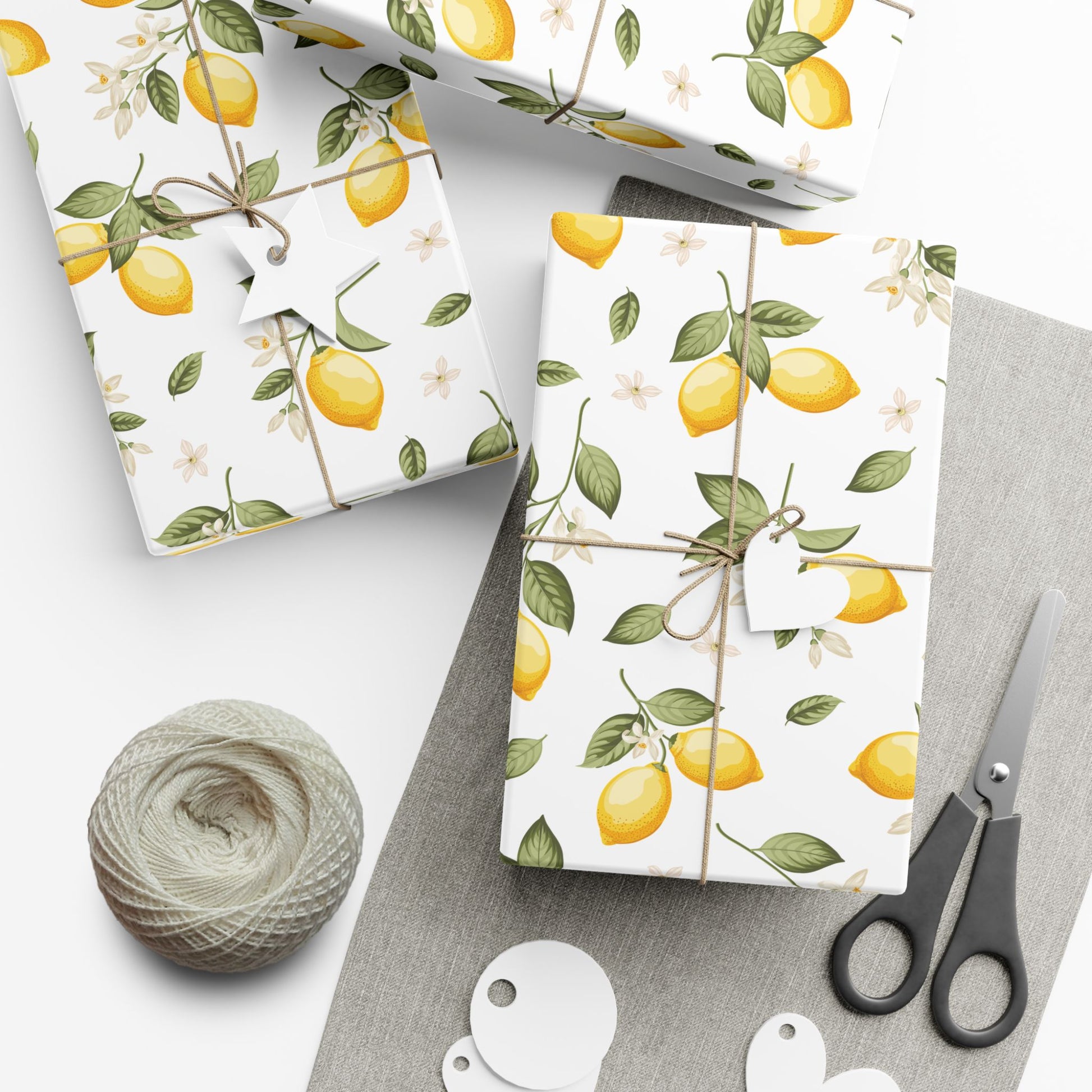 Gifts wrapped in lemon blossom paper with scissors and twine