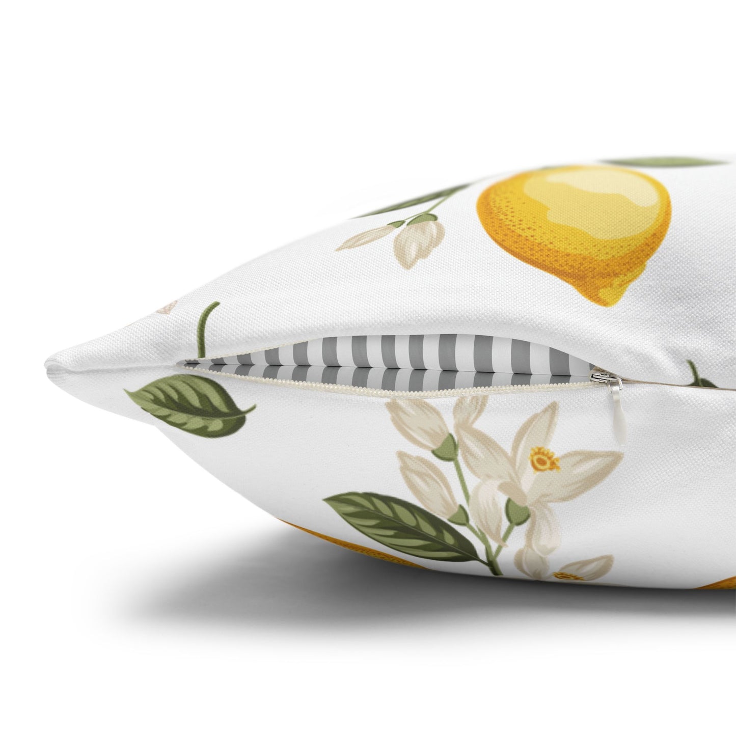 Close-up detail of the lemon branch throw pillow showing the concealed zipper, lemon fruit, and white flowers with striped back panel