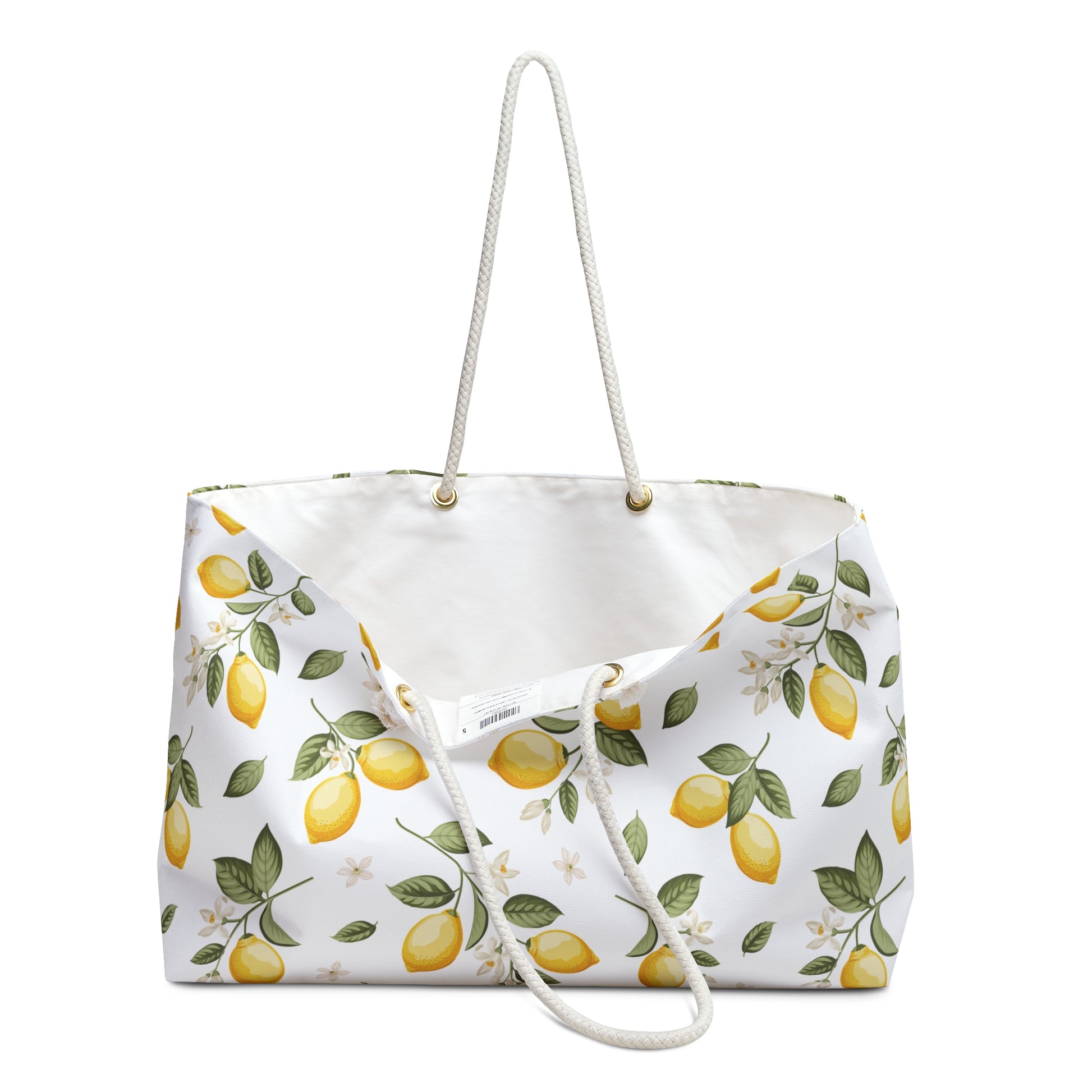 Lemon pattern weekender bag open at the top showing the cream interior lining, rope handles, and grommets